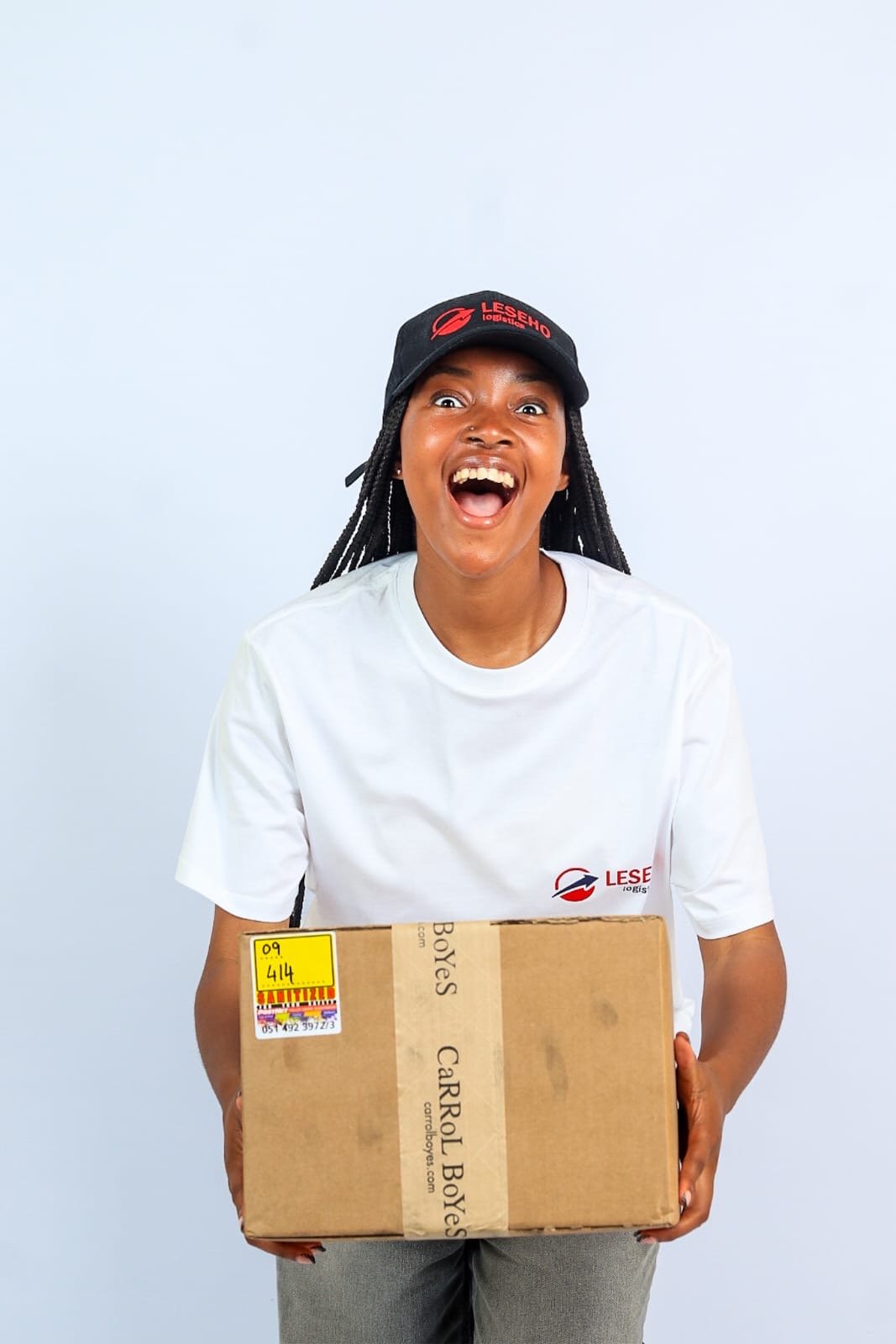 Leseho Logistics courier smiling with a package